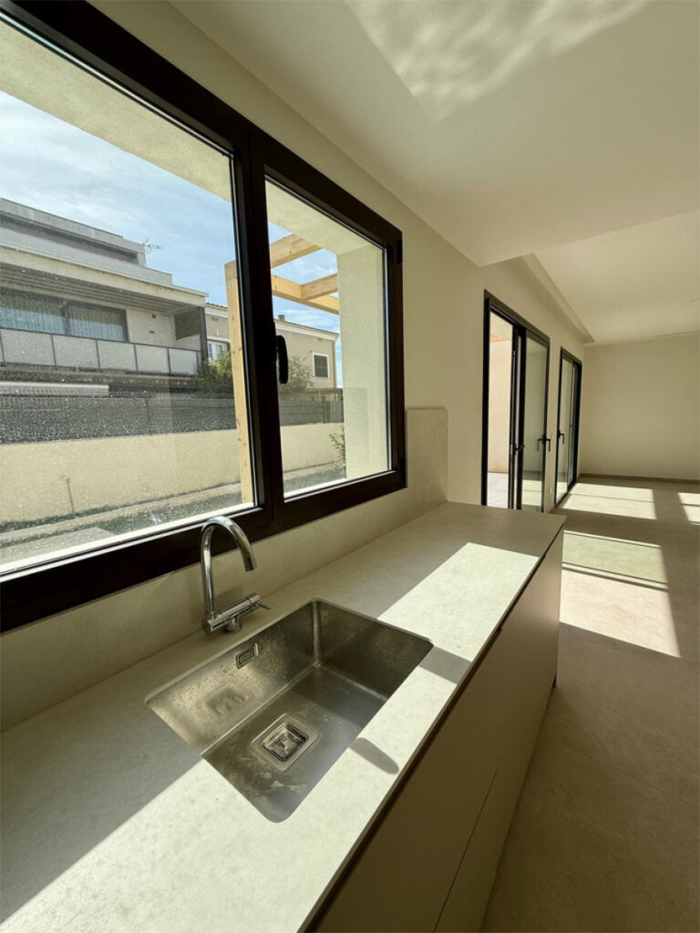 Offene Küche mit Fensterfront zum Garten